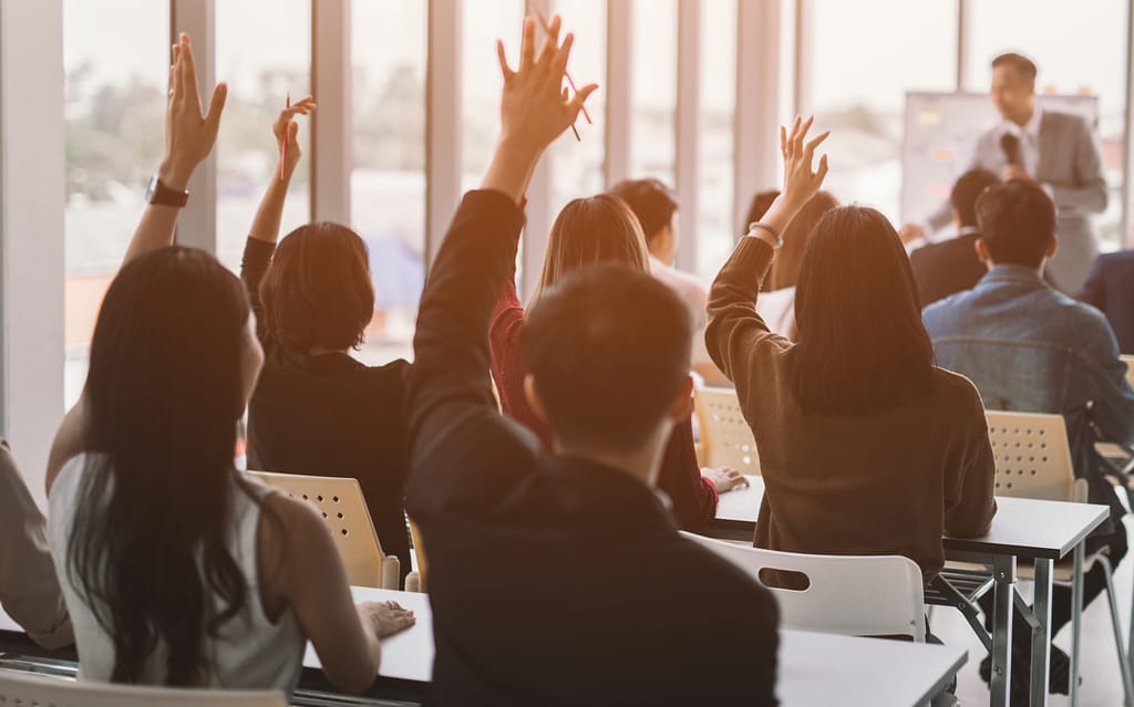 data science course Raised up hands and arms of large group in seminar class room to agree with speaker at conference seminar meeting room