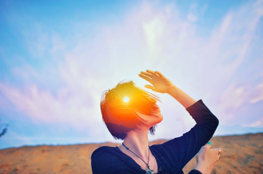 Shaman ritual, psychology freedom, mystic power of mind concept Double multiply exposure head portrait of a spiritual woman praying outdoors with closed eyes on nature, sunrise or sunset, closeup.