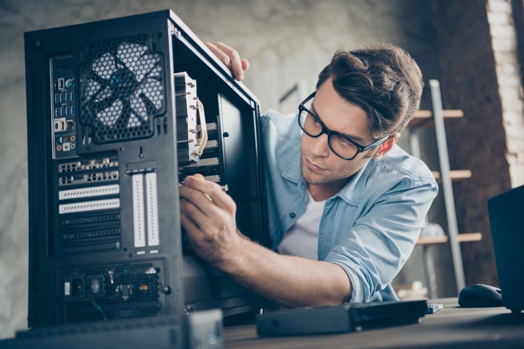 Close-up portrait of his he nice, attractive focused professional guy skilled technician repairing hardware detail fan cooler support at modern loft industrial home office work workplace workstation