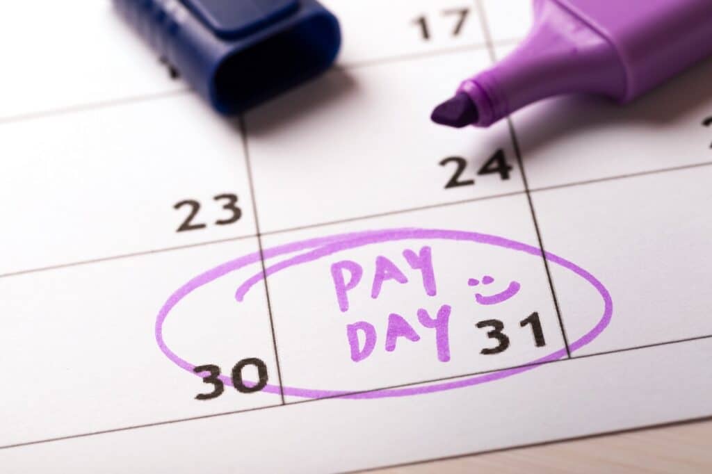 payday concept calendar with marker and circled day of salary