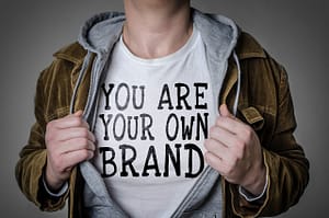 Man showing 'You Are Your Own Brand' title on his t-shirt.