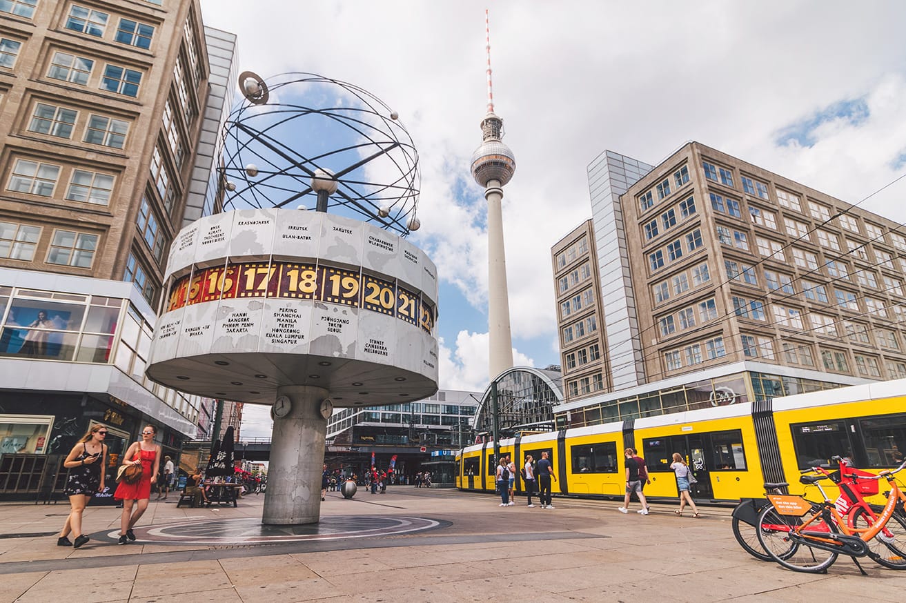 World time clock at Berlin Alexanderplatz with TV tower in the background.