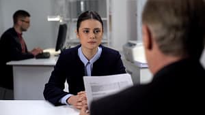 Boss checking female employee work results, probationary period at workplace