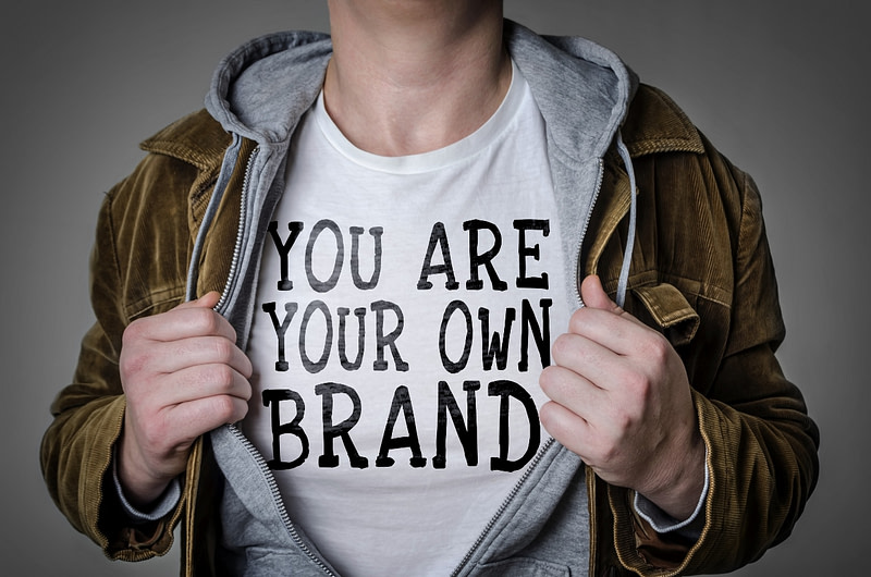 Man showing 'You Are Your Own Brand' title on his t-shirt.